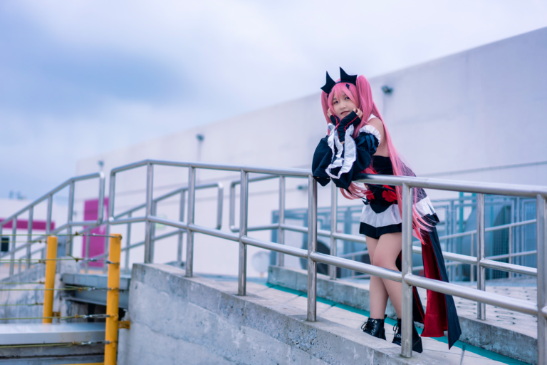 Girl in pink hair and a maid outfit leaning over a railing.