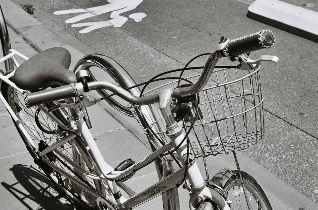 Close-up black and white photo of a mamachari with a wire basket at the front.