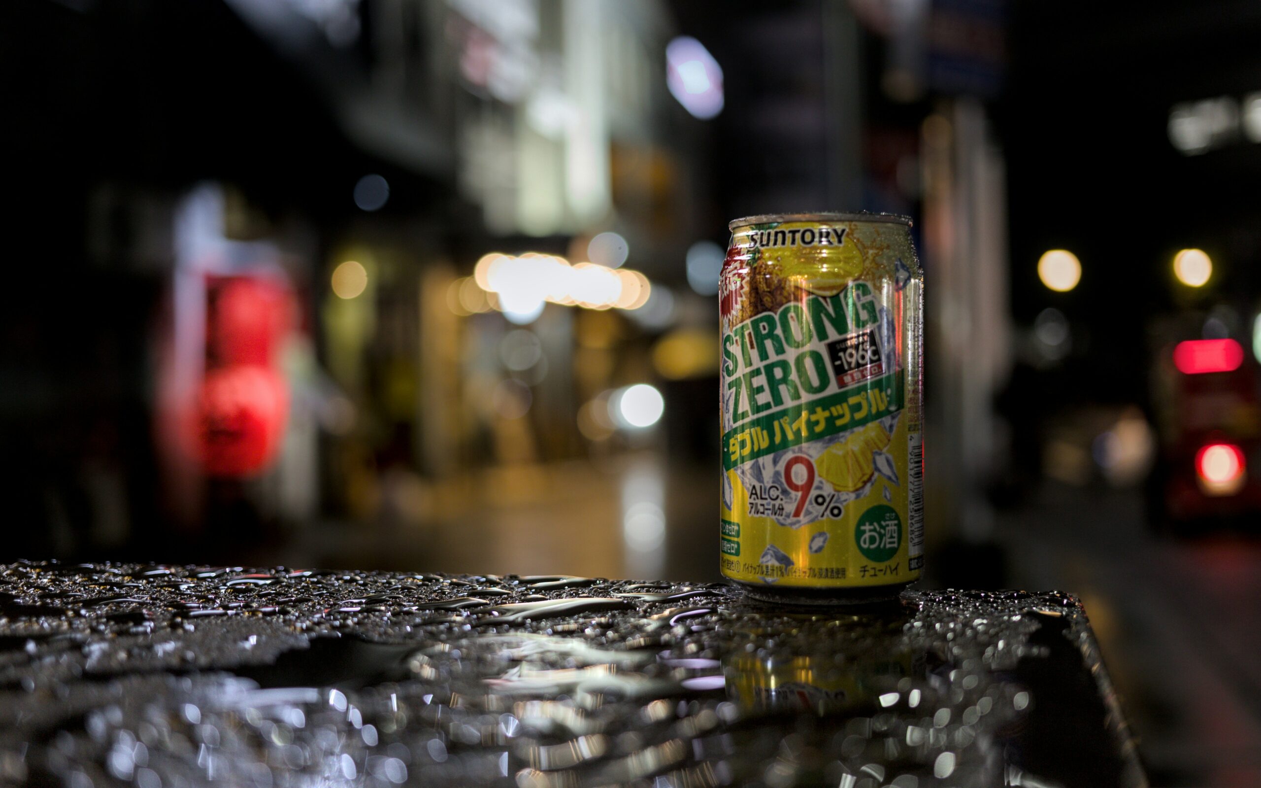 A can of lemon Strong Zero in Tokyo at night.